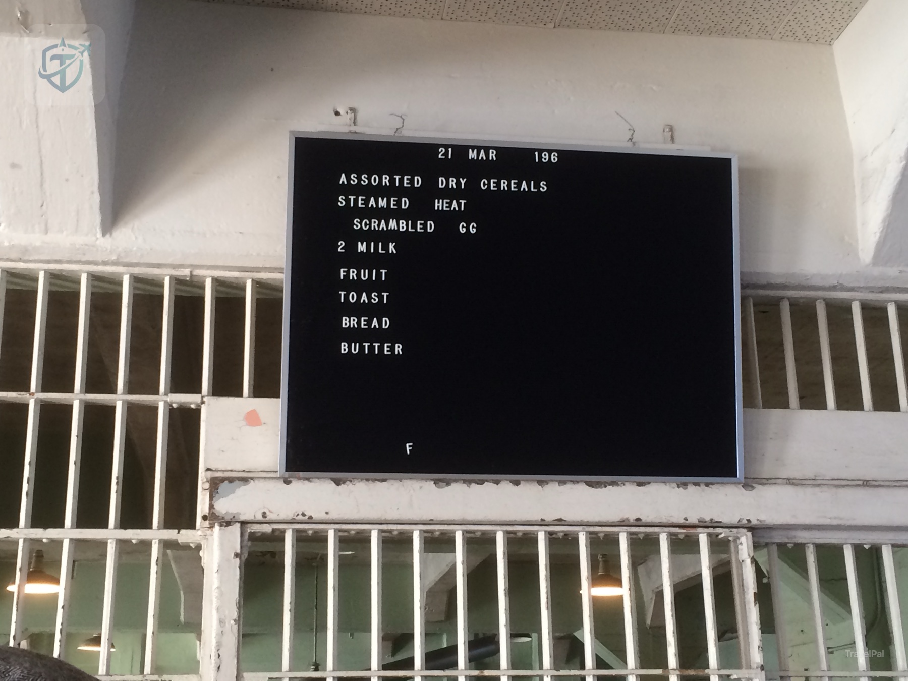 Historic Alcatraz prison menu board showing a daily meal list behind bars