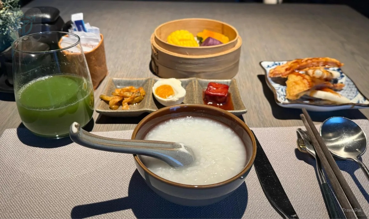 Shanghai-style breakfast with congee, dim sum, vegetables, juice, and small dishes at Alila Shanghai