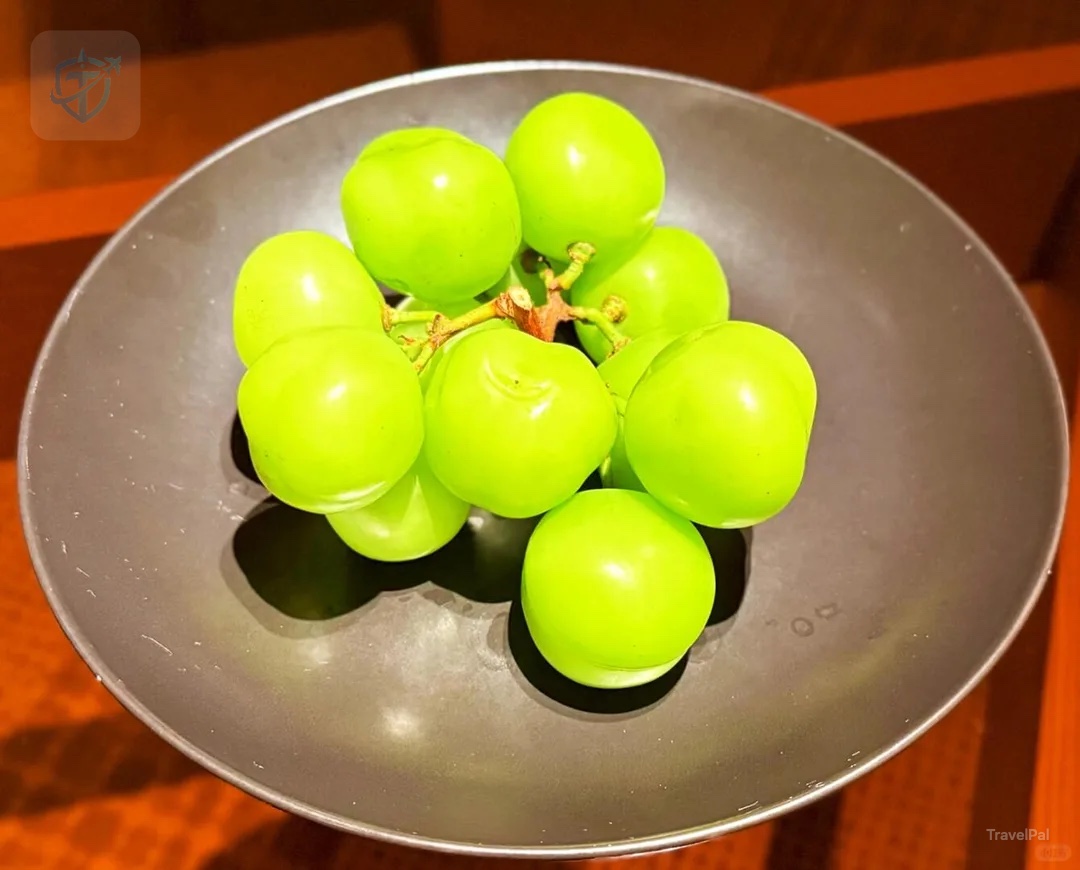 Bright green welcome grapes presented in a dark ceramic bowl at Alila Shanghai