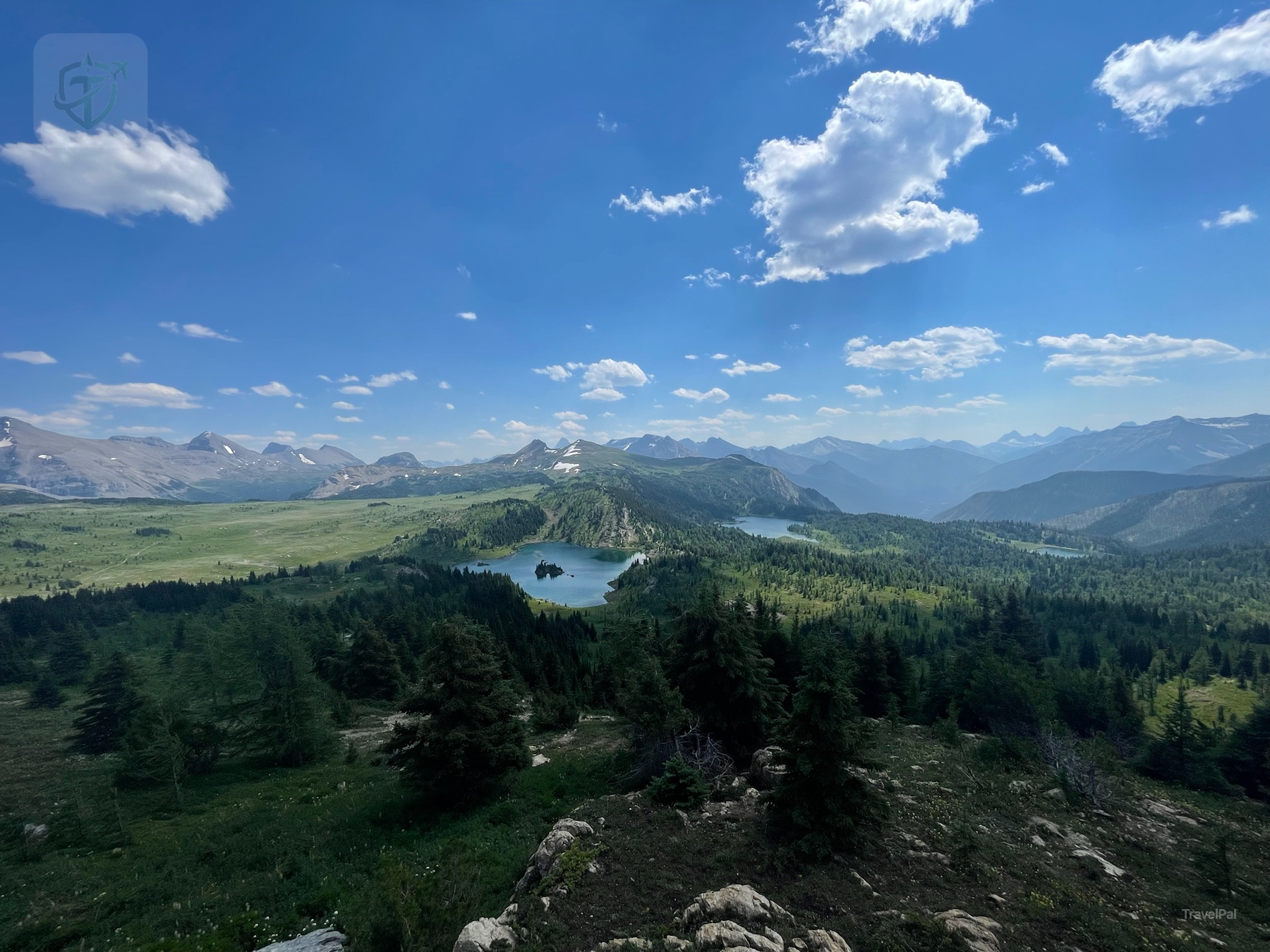 Wide alpine panorama of Sunshine Meadows and the Canadian Rockies beneath a blue sky