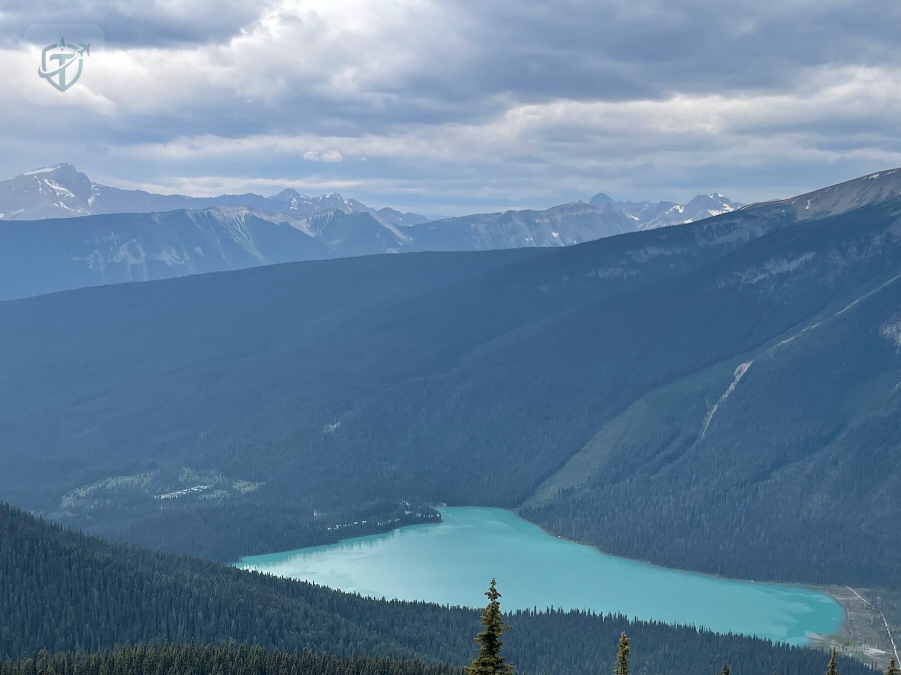 Turquoise lake and layered mountain valleys seen from high on the Burgess Shale route