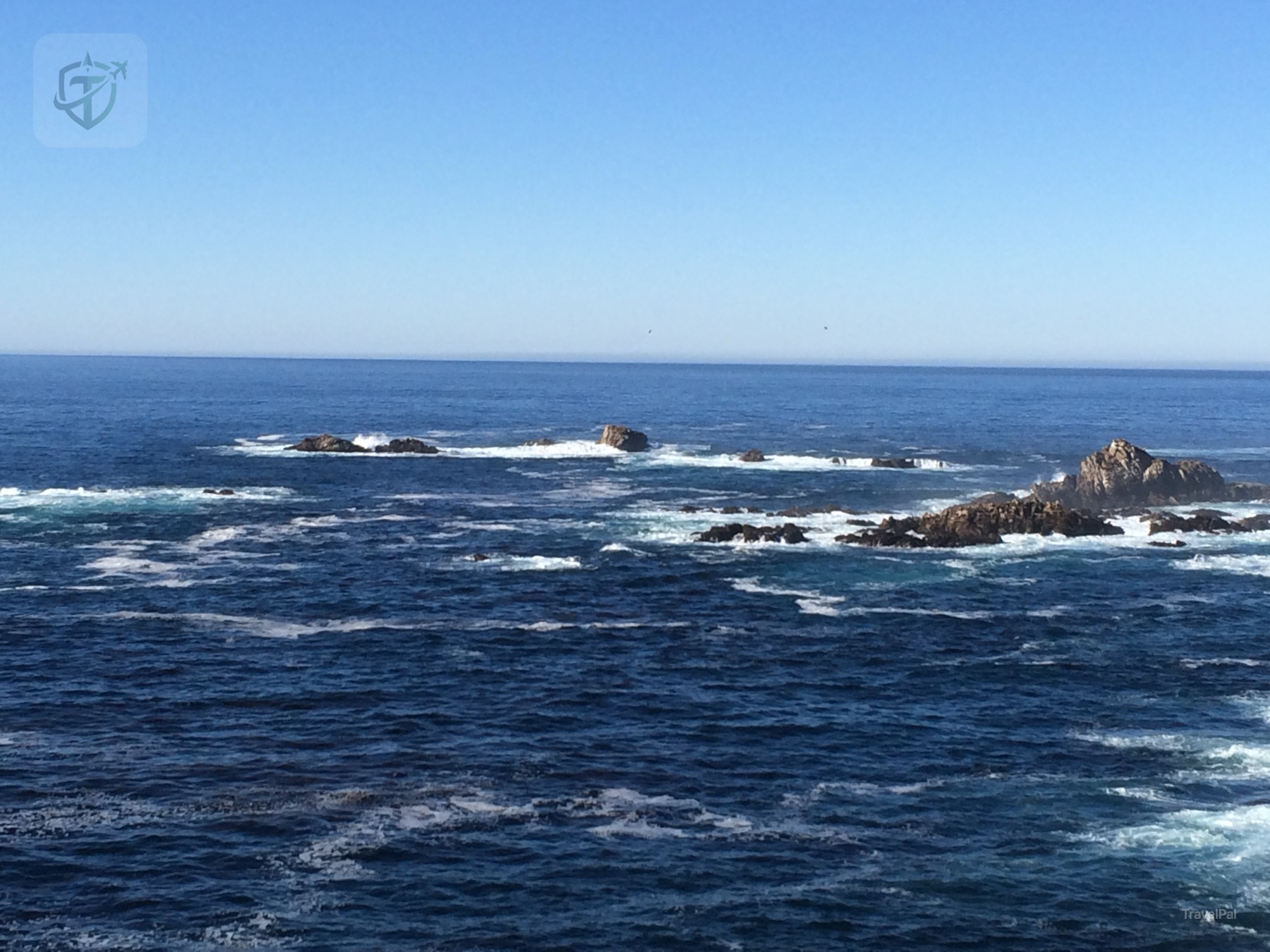 Offshore rocks surrounded by deep blue Pacific water along Highway 1