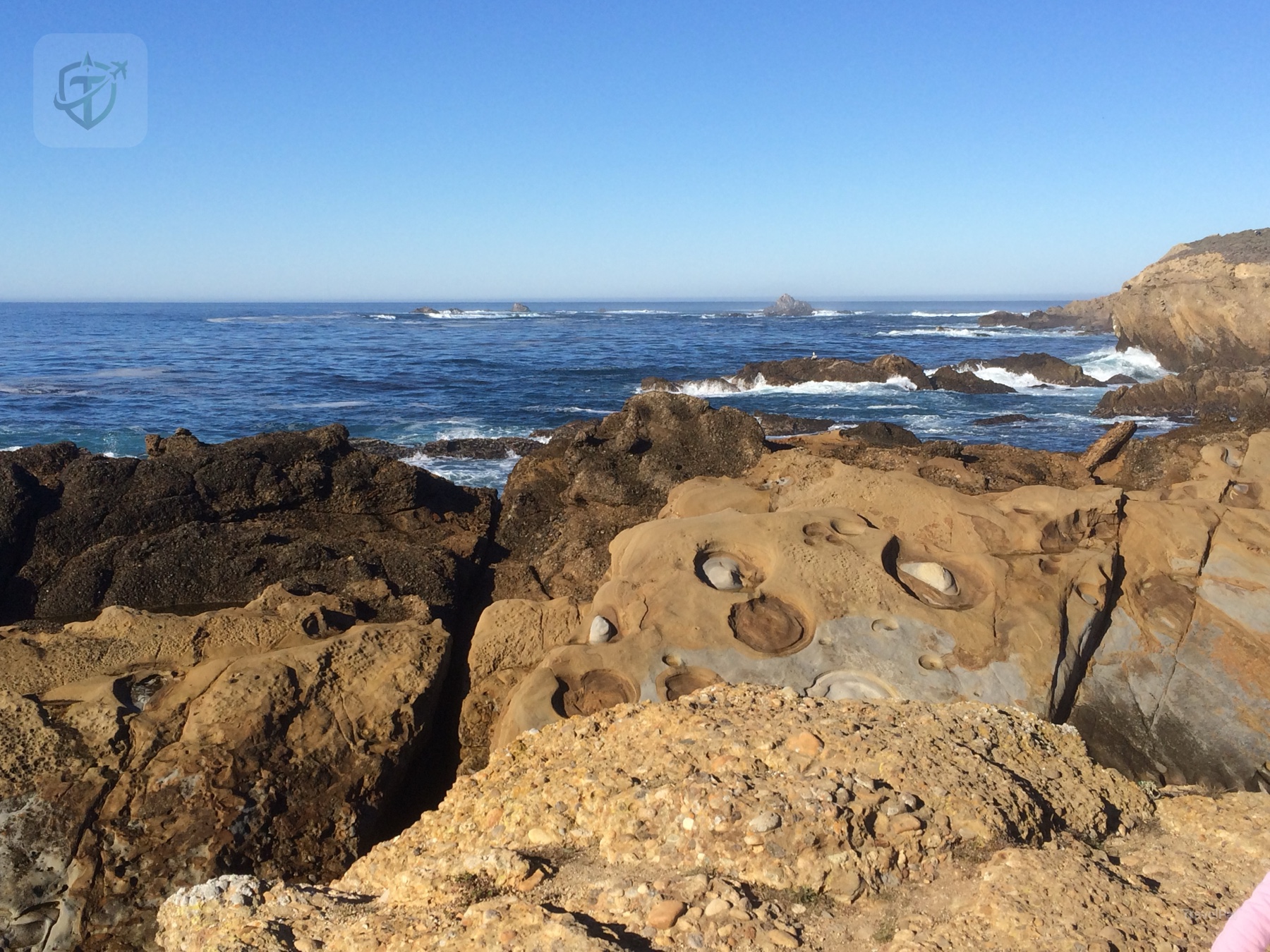 Rocky tide pools and small waves along the California coast
