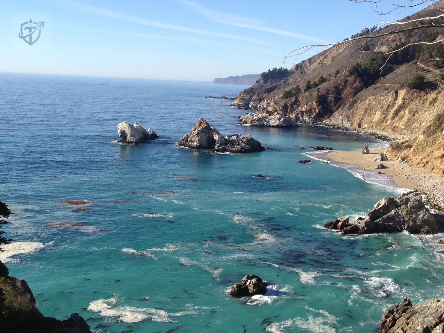 Turquoise cove tucked beneath California coastal cliffs