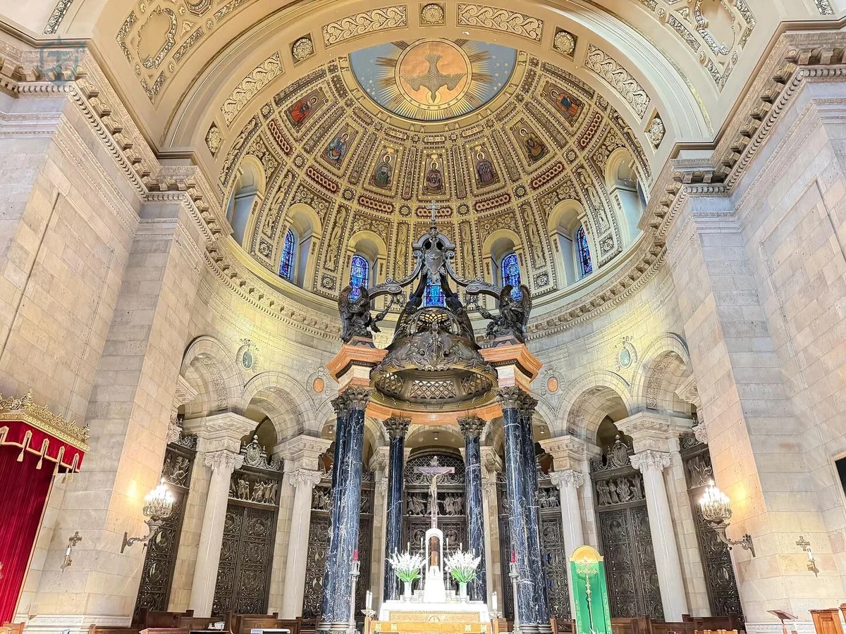 Cathedral high altar beneath a black marble baldachin and decorated sanctuary dome