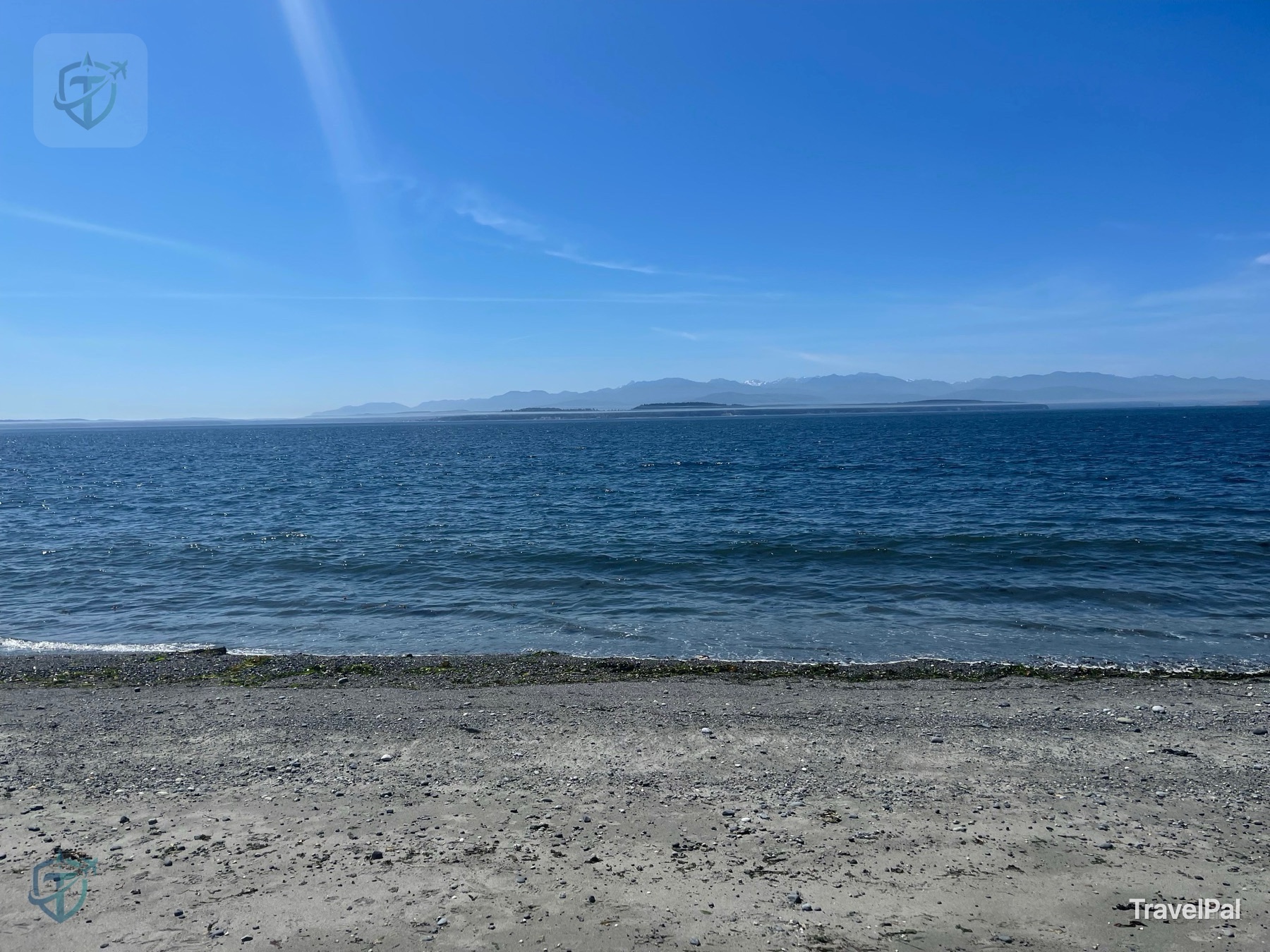 Open Puget Sound and distant mountain ranges seen from the shore at Ebey’s Landing