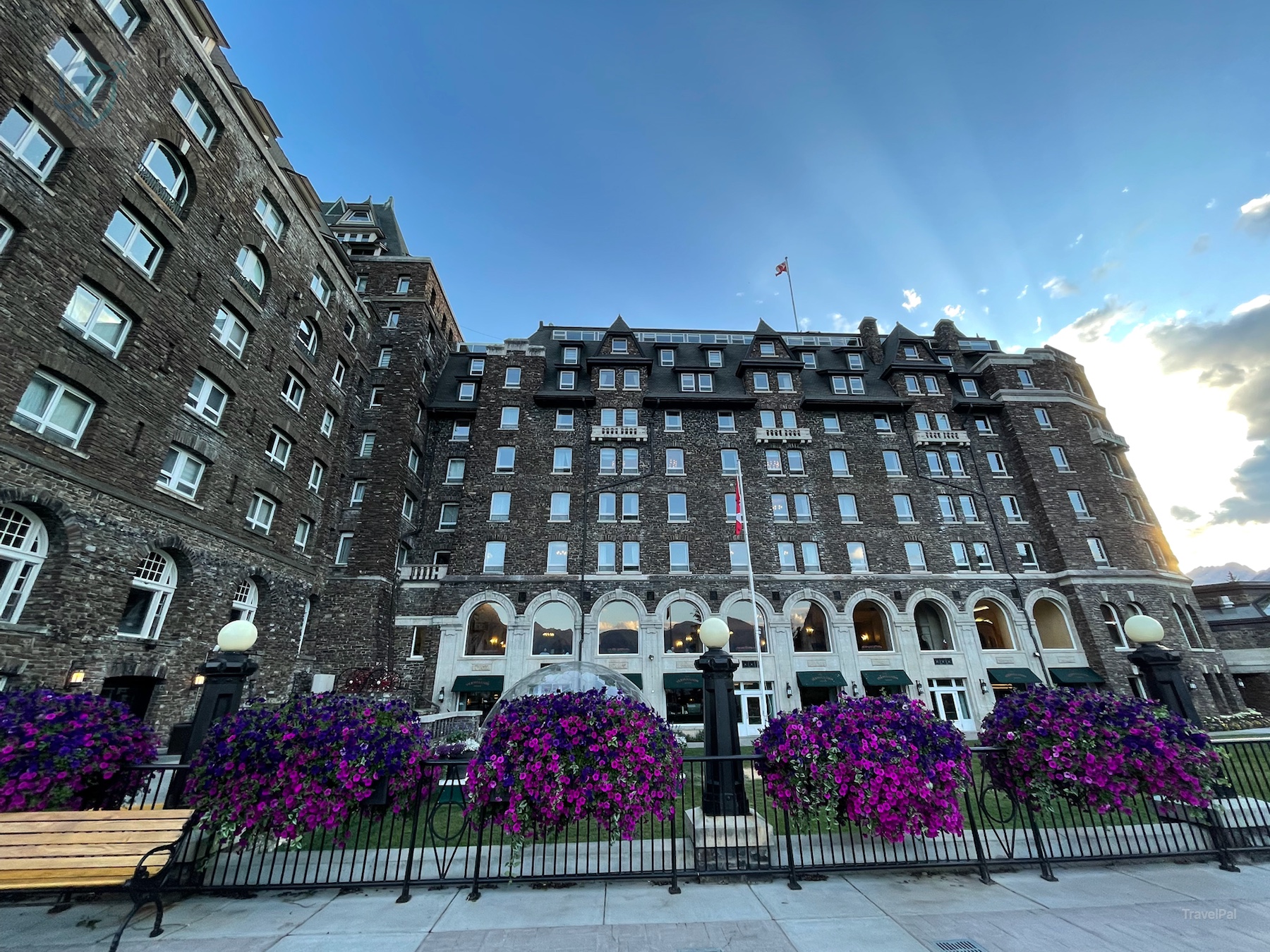 Fairmont Banff Springs stone facade and arched entrance beneath a blue evening sky