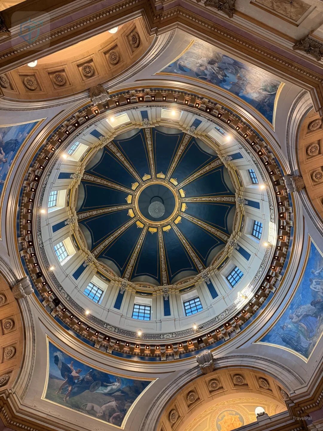 Painted panels and blue-green windows around the Minnesota Capitol rotunda dome