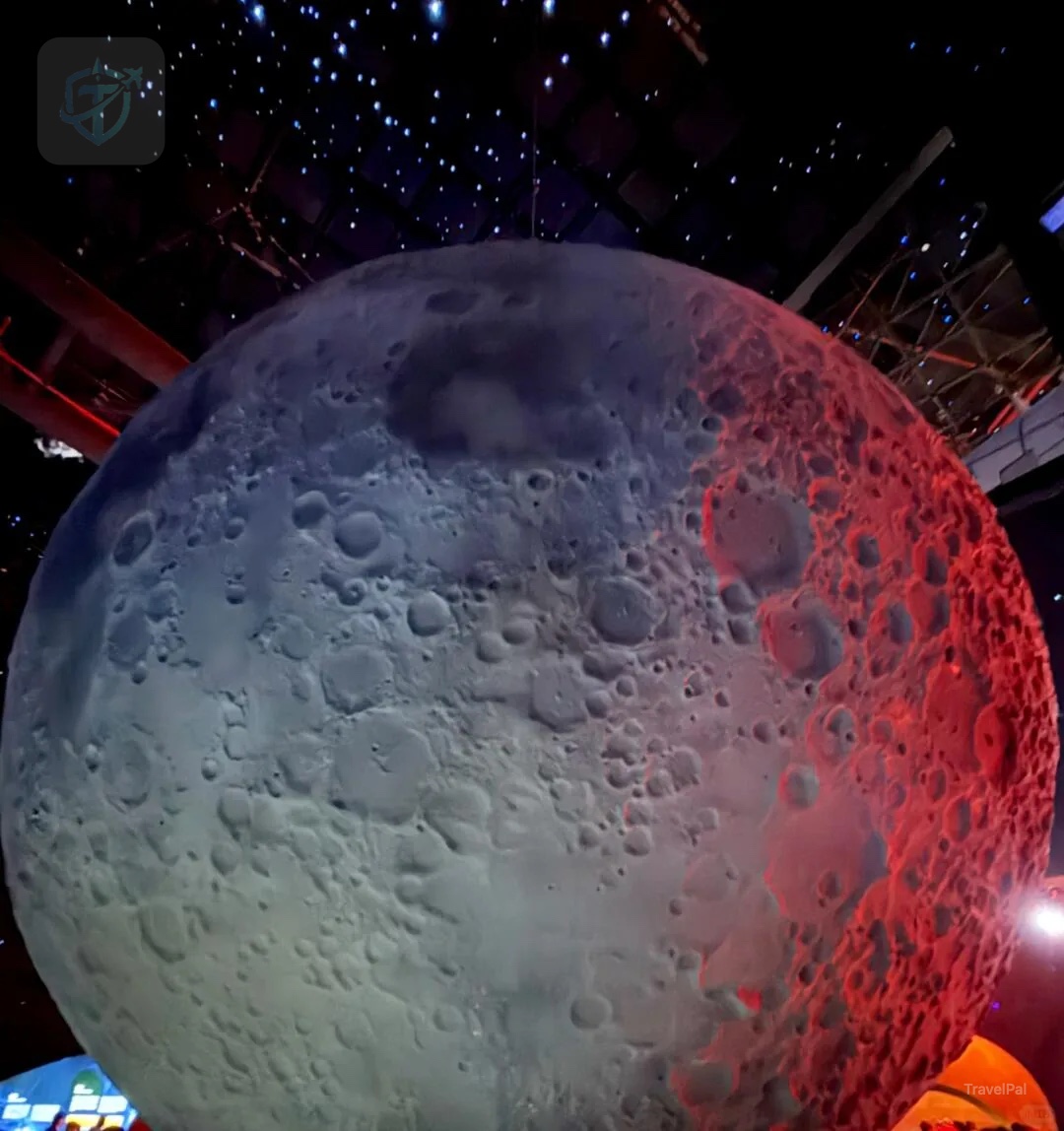 Large illuminated Moon model beneath a starry ceiling at Shanghai Astronomy Museum