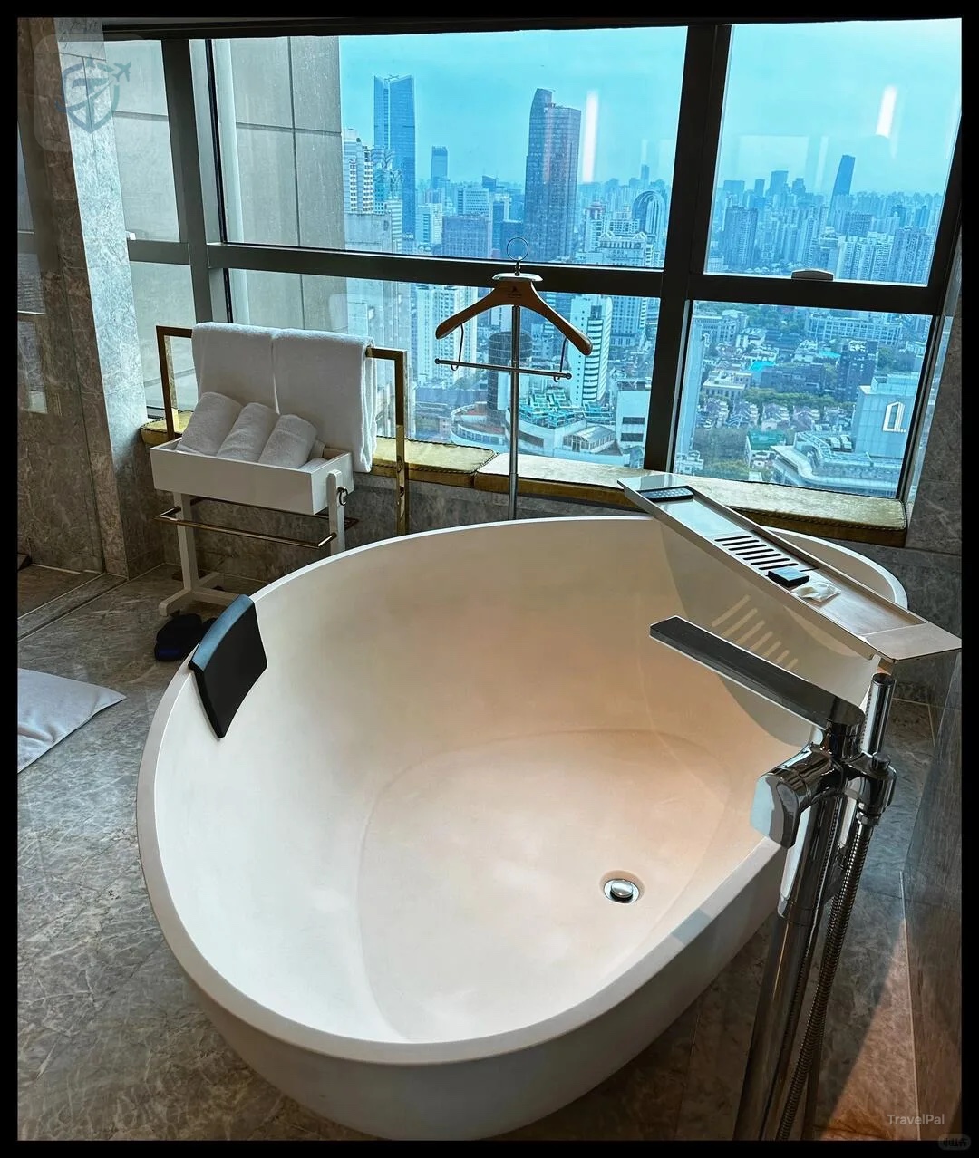Freestanding bathtub by a window in a St. Regis Shanghai suite