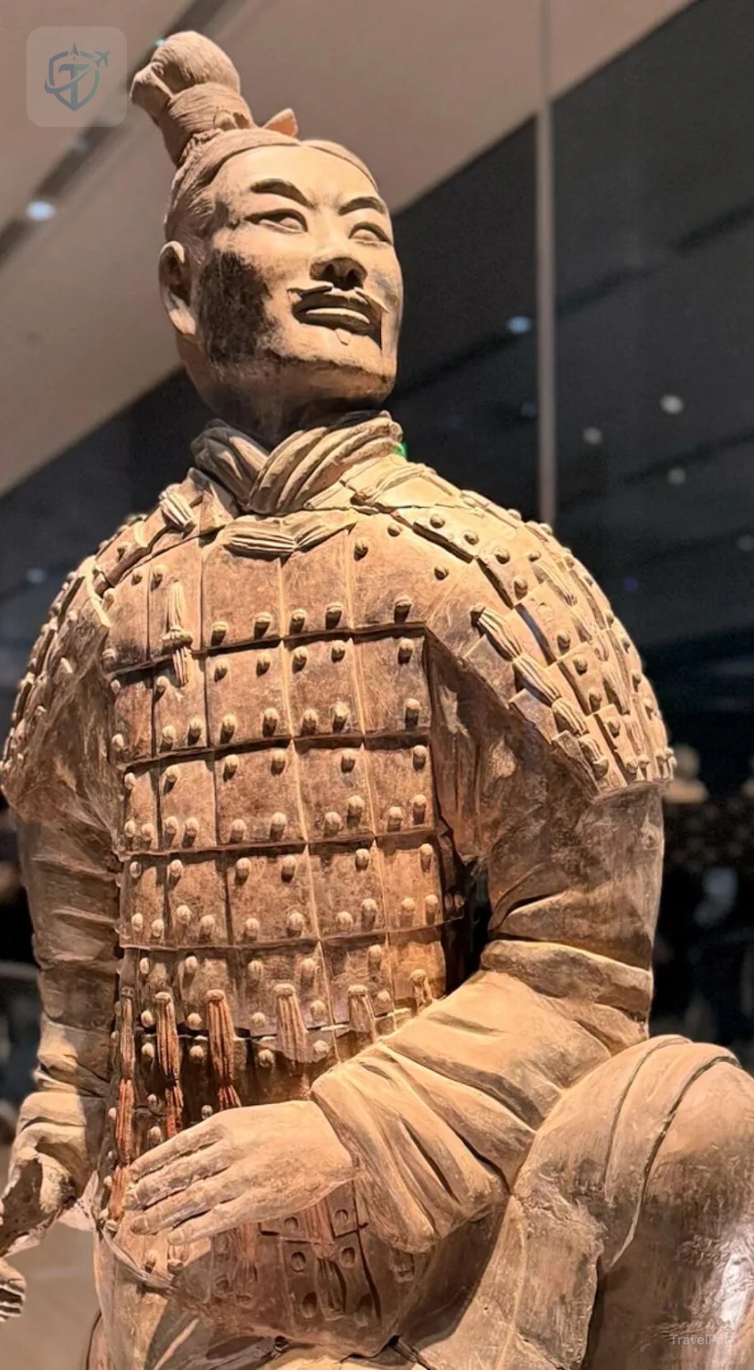 Close view of a kneeling terracotta archer showing detailed armor and hairstyle